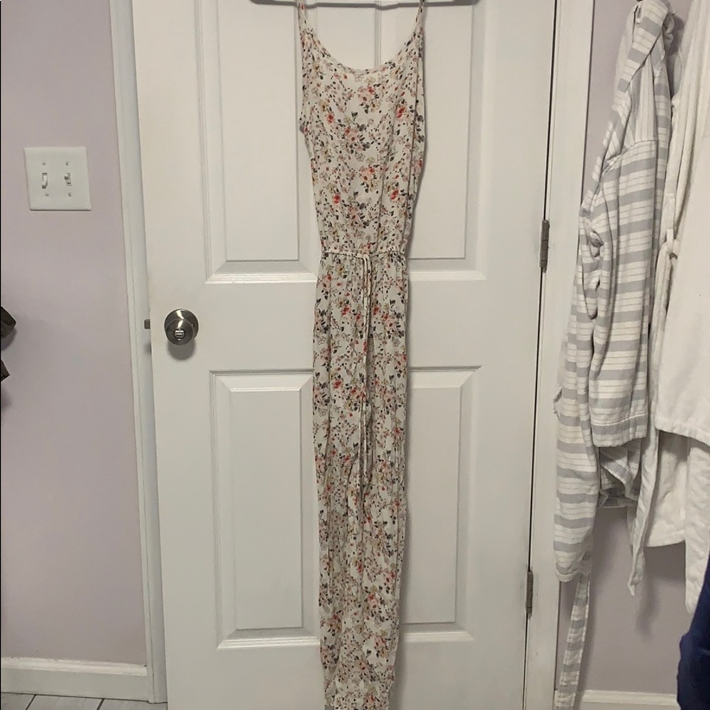 Boutique floral jump suit with V back size M